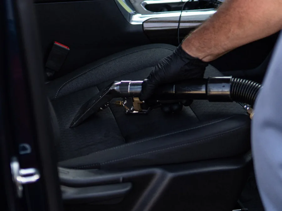 Hot-water extractor tool on a cloth car seat
